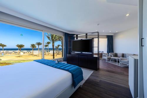 a hotel room with a bed and a television at Sataya Resort Marsa Alam in Marsa Alam City