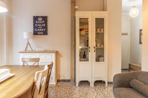 a dining room with a table and a cabinet at L'Erika in Città in Livorno