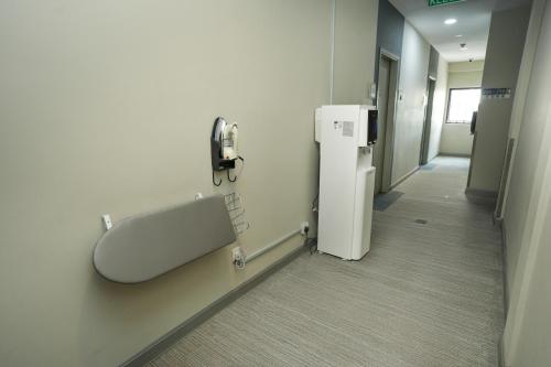 a hospital hallway with a phone on the wall at GM Grand Moments Bandar Sunway in Petaling Jaya
