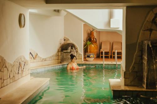 a woman is in a swimming pool at Hotel Terme Zi Carmela in Ischia