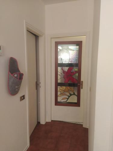 a hallway with a door with a stained glass window at Civico 21-FreeParking in Vescovato