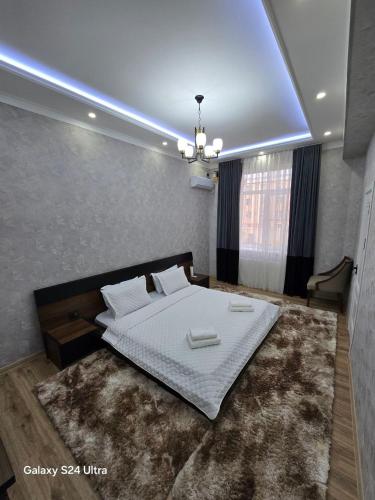 a bedroom with a large bed with a large rug at Golden house deluxe in Bukhara