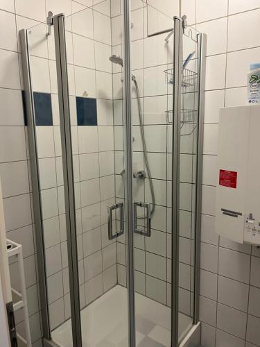 a shower with glass doors in a bathroom at BM Rooms - Bamberger Gemütlichkeit in Bamberg