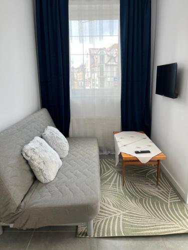 a living room with a couch and a table at City Center Szczytno I in Szczytno
