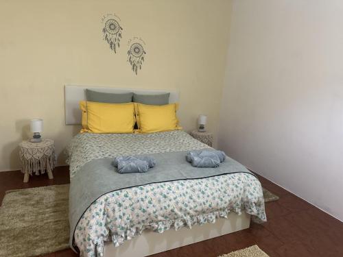 een slaapkamer met een bed met twee blauwe handdoeken erop bij Casa Mary Bela's in Ponta do Sol