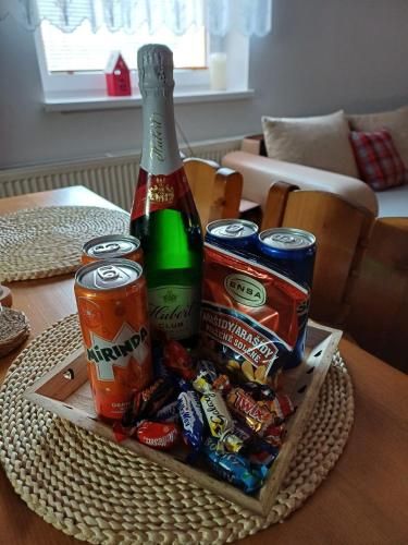 a tray with a bottle of beer and snacks on a table at Vila Pohoda Javorníky s rozľahlým pozemkom in Makov