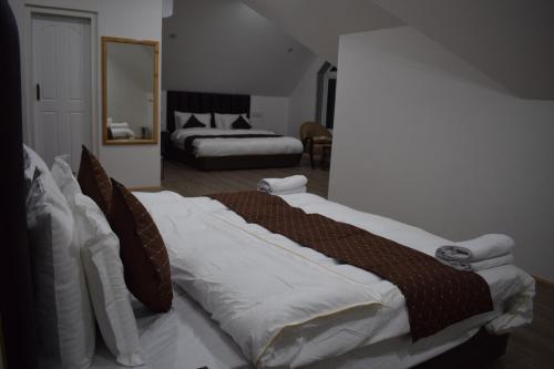 a large bed in a room with a bedroom at Ambience in Srinagar