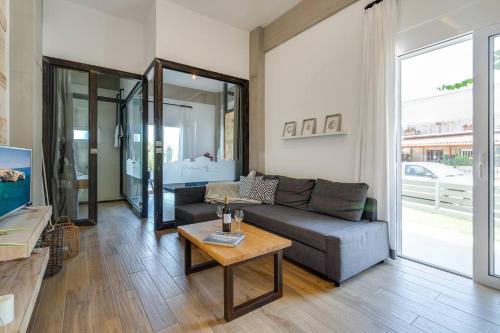 a living room with a couch and a table at Chania Urban Living - Live like a local in Chania Town