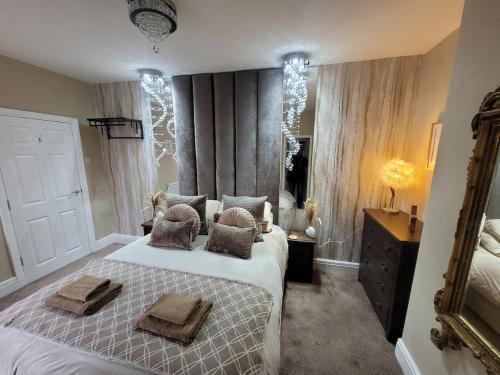 a bedroom with a bed with two towels on it at Tower Suites - HOT TUB sleeps 14 in Blackpool