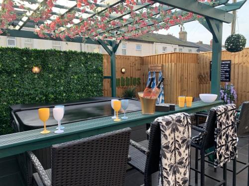 a table with wine glasses on a patio at Tower Suites - HOT TUB sleeps 14 in Blackpool