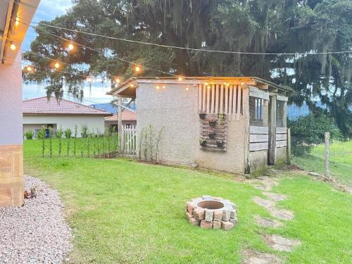a backyard with a small house with lights on it at Casa de temporada - Tatuhouse in José Boiteux