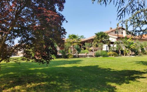a house in a yard with a green lawn at Chambres d'hotes "Chez Marchio" in Crottet