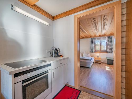 a kitchen with a door leading to a living room at Elisabeth II in Wald im Pinzgau