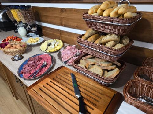 a table with baskets of bread and other food at Hotel Slavie in Špindlerův Mlýn