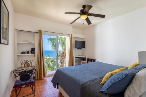 a bedroom with a bed and a view of the ocean at MariaMar Suites in San José del Cabo