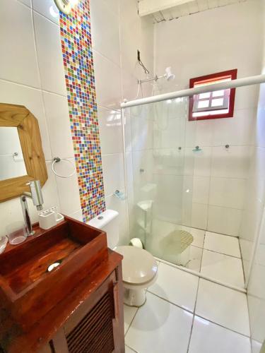 a bathroom with a shower and a toilet at Pousada e Residencial Linda in Capão da Canoa