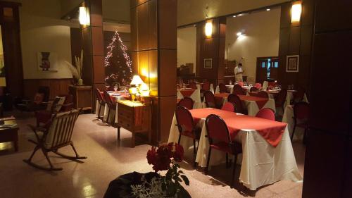a dining room with tables and chairs and a christmas tree at Montecassino in Capilla del Monte