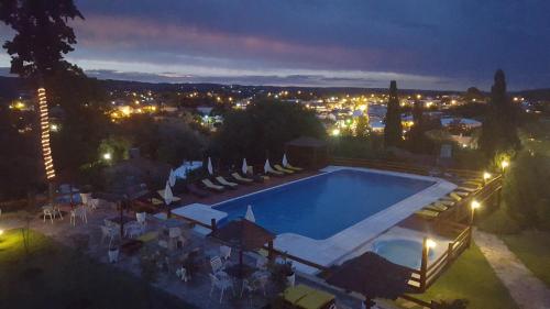 an overhead view of a swimming pool at night at Montecassino in Capilla del Monte
