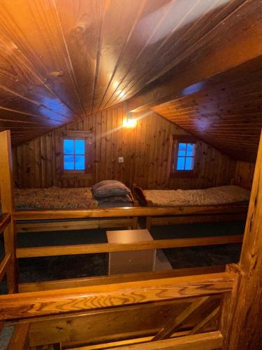 an attic room with two beds in a cabin at Les Rhodos in Veysonnaz