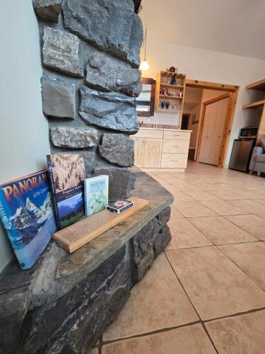 a stone wall in a kitchen with a bench at Pika's Place Bed and Breakfast in Canmore