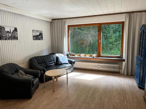 a living room with a couch and a table and a window at Ruhiges Ferienhaus in Burgnähe in Cochem