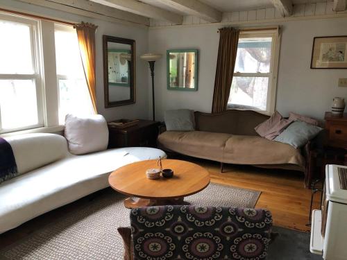 a living room with a couch and a table at Charm at the foot of the Berkshires in Hillsdale