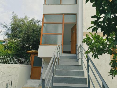 a staircase leading up to a building with a glass door at La casa della Nonna in Piqeras