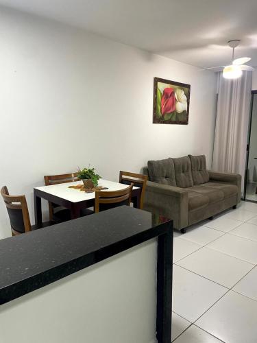 a living room with a couch and a table at Varanda Gourmet Diversão Pet Praia do Francês in Praia do Frances