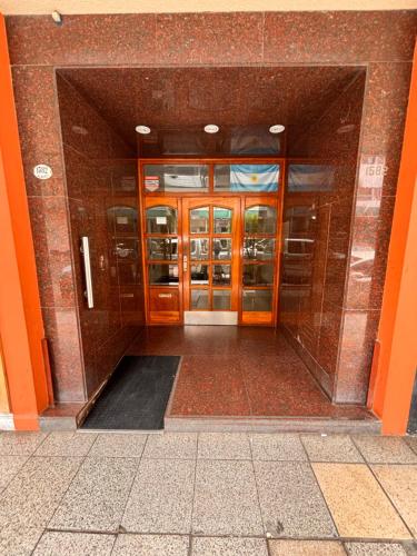 an entrance to an office building with orange doors at Mar del Plata Departamento Zona Aldrey in Mar del Plata