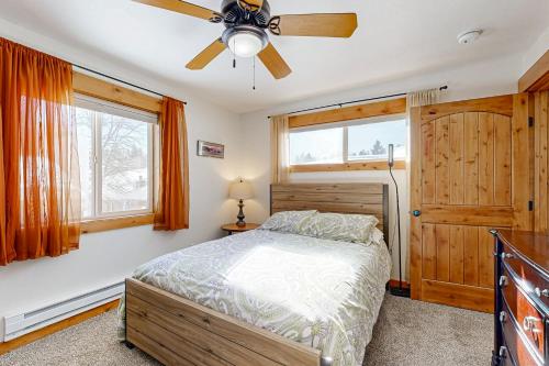 a bedroom with a bed and a ceiling fan at The Ponderosa at Aspen Village in McCall