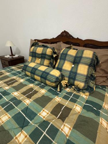 a bed with two pillows on top of it at House Mariona in Caminha