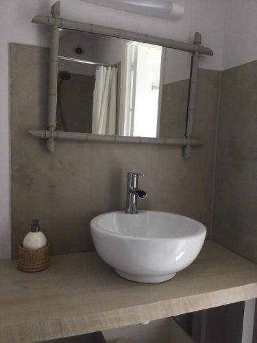 une salle de bain avec un lavabo blanc et un miroir dans l'établissement Paimpol centre tout à pieds avec extérieur !, à Paimpol