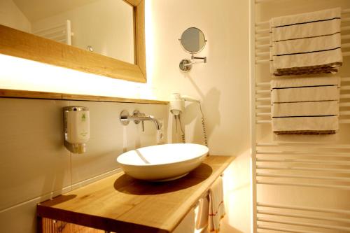 a bathroom with a bowl sink and a mirror at Flair Hotel Nieder in Bestwig