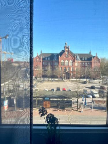 a view of a large building from a window at Pension Brema Apartment 1 Zimmer in Bremerhaven