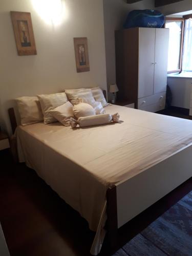 a bedroom with a large bed with white sheets and pillows at borgo romantico in Villar Dora