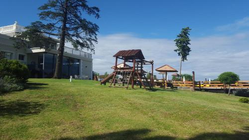 a playground with a slide in a yard at Montecassino in Capilla del Monte