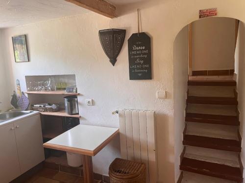 a kitchen with a sink and a staircase in a room at Domaine La Cigogne, Provencal house with pool & big garden in Vence
