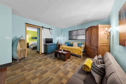 a living room with a couch and a bedroom at Blue Bell Apartment Hotel in Fort Lauderdale