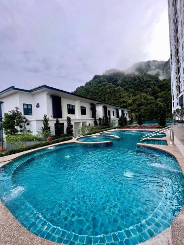 a large swimming pool in front of a building at 2-8pax Ipoh Nomado Onsen suites by Sunway Onsen Lost world of Tambun in Ipoh