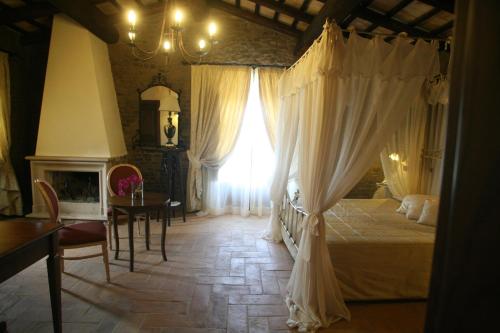 a bedroom with a bed and a window and a table at Relais Castrum Boccea in Boccea