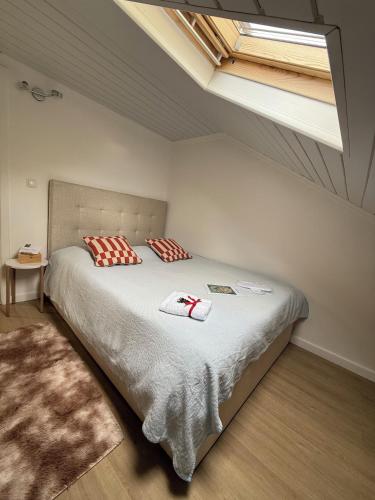 a bedroom with a bed with two pillows on it at Casa do sol in Santa Cruz