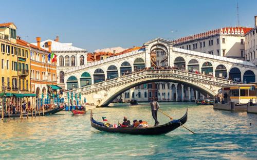 a group of people in a gondola on a canal in front at B&B New Aurora Venice in Marghera