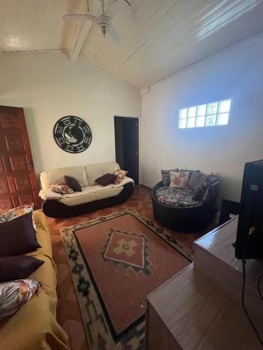 a living room with a couch and a chair at Casa, hidro, piscina, aconchego e uma linda vista! in Mairiporã