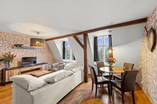 a living room with a couch and a table at Stylisch Apartments Berlin Mitte, group & family friendly, from 2 - 8 Guests in Berlin