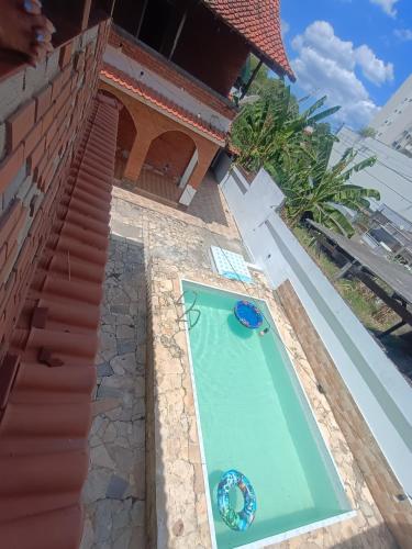 een zwembad aan de zijkant van een huis bij Residence Hotel Efrata Centro Itaborai in Itaboraí
