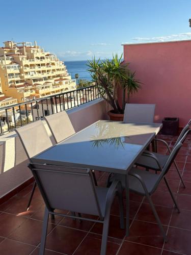 a table and chairs on a balcony with a view of the ocean at El Ático de Brisaquebrada - Vista Mar - Gran Terraza in Benalmádena