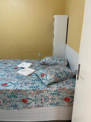 a bedroom with a bed with a laptop on it at Pousada Green Aeroporto Rodoviária in Fortaleza