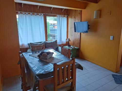 a living room with a table and a couch at La casa de Gaby in San Martín de los Andes