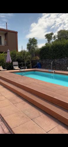 a swimming pool with stairs next to a house at Villa Luigi in Valverde