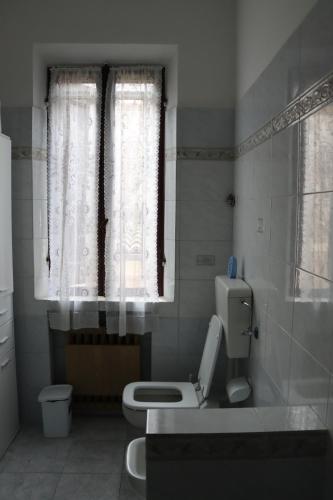 a bathroom with a toilet and a window at Giovanna's House in Montale